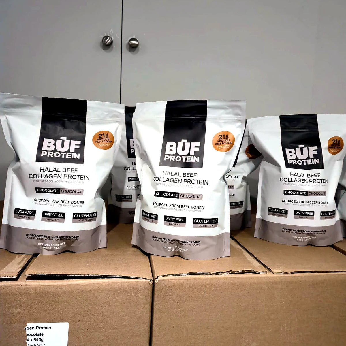 BUF Protein chocolate collagen pouches lined up on cardboard boxes